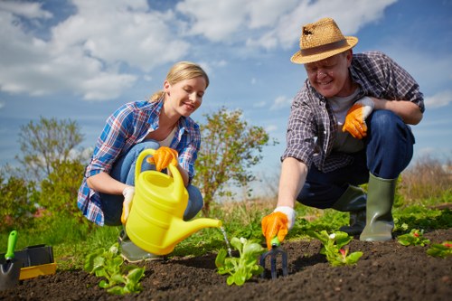 Workers measuring garden waste for cubic-yard estimate